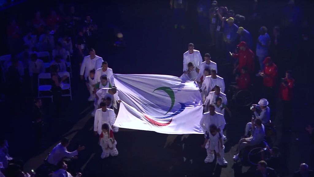 Crianças sem mobilidade nas pernas caminharam com a bandeira paralímpica graças a um pai dedicado