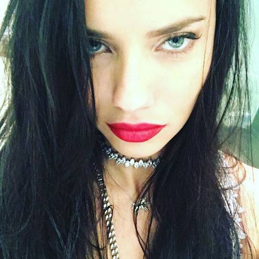 Adriana Lima apostou no look fatal, com cabelos lisos e soltos, c&iacute;lios alongados e batom vermelho.