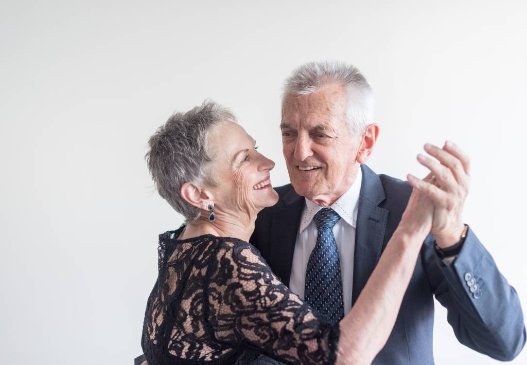 Elegantly dressed older couple dancing