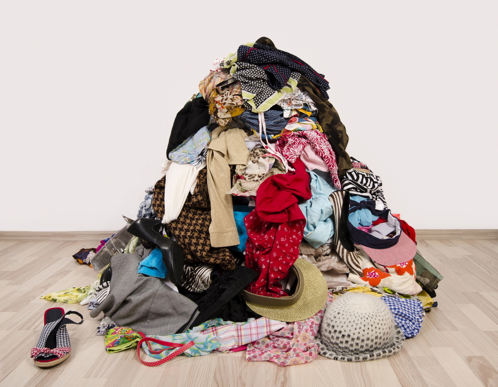 Big pile of clothes and accessories thrown on the floor.