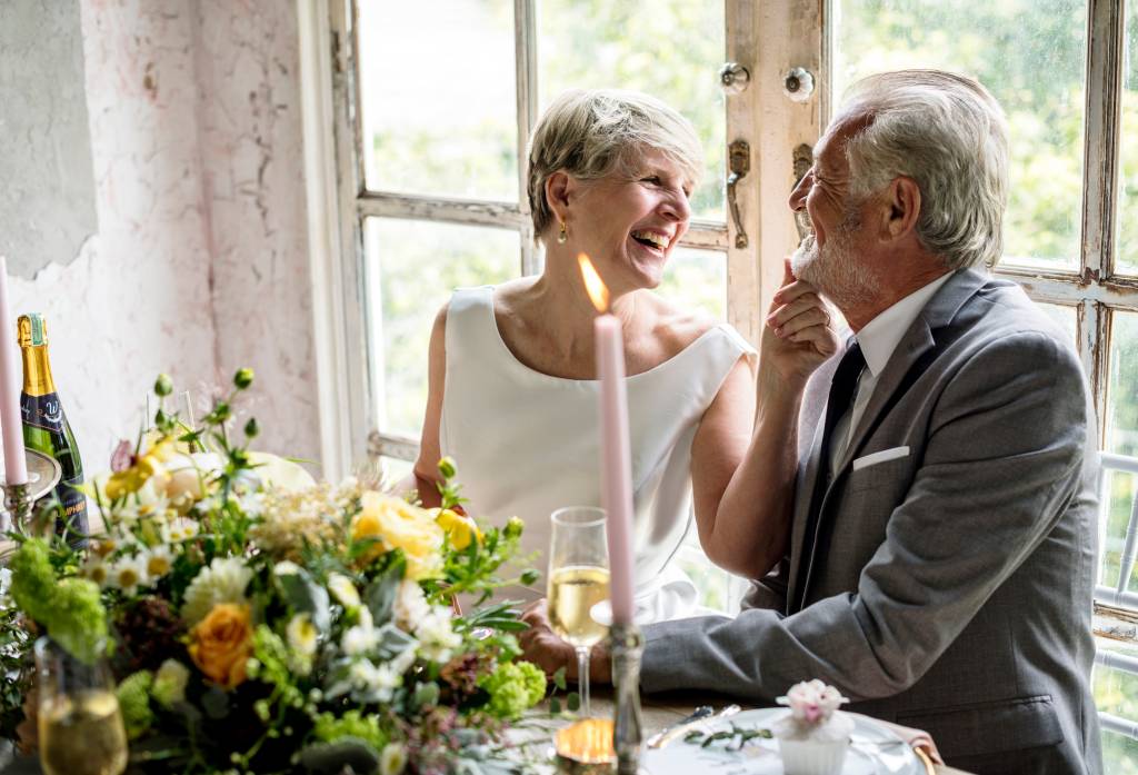 Senior couple sitting laughing together