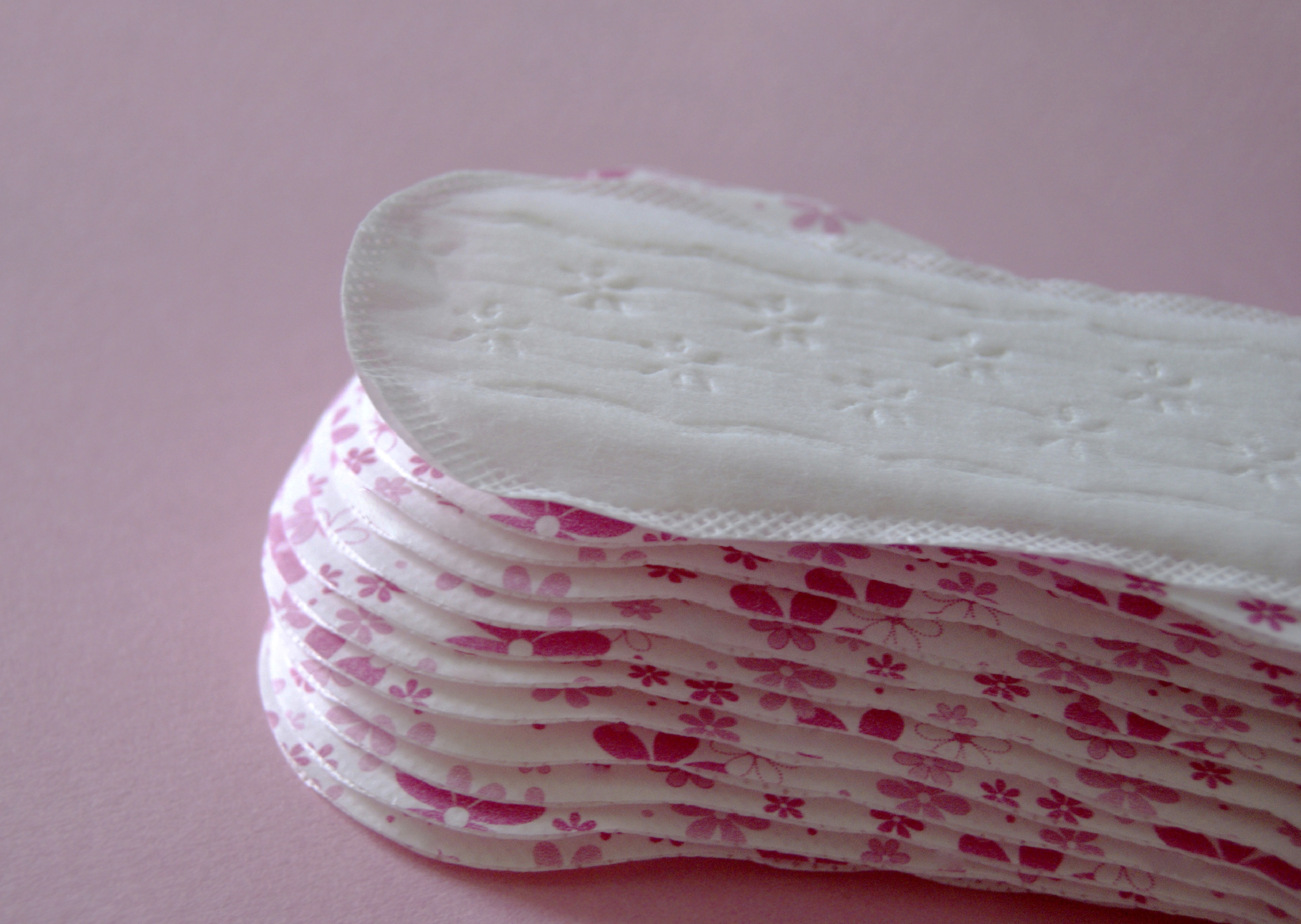 Intimate feminine napkins on pink background