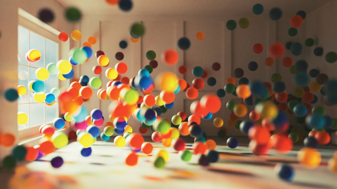 Bolas coloridas em movimento numa sala vazia