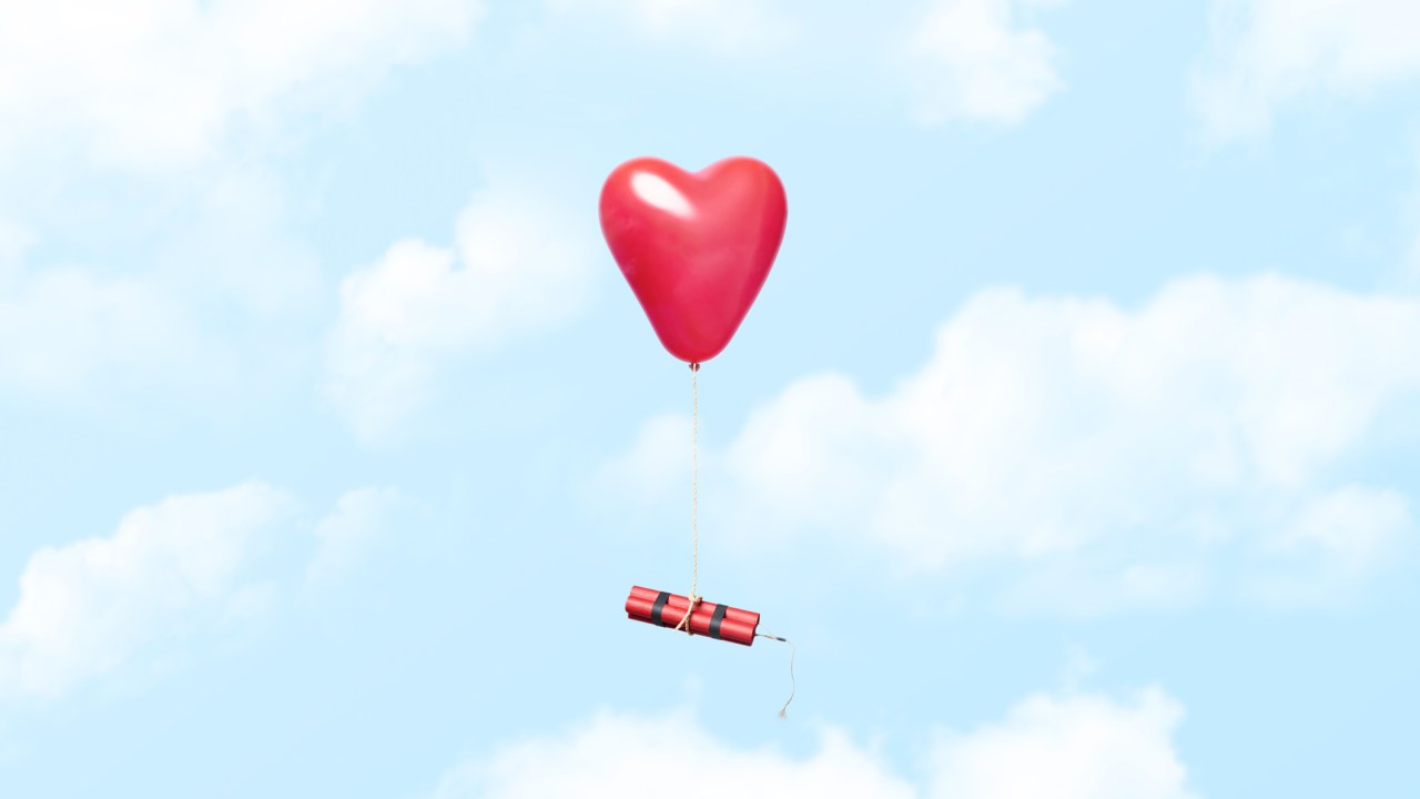 Conceptual photograph of a heart shaped red balloon tied to a dynamite bundle floating in the clouds, could illustrate concepts related to bad love relationships and similar. Could also illustrate the opposite of being newly in love were everything is exciting and a little dangerous in a good way or even just the thrill