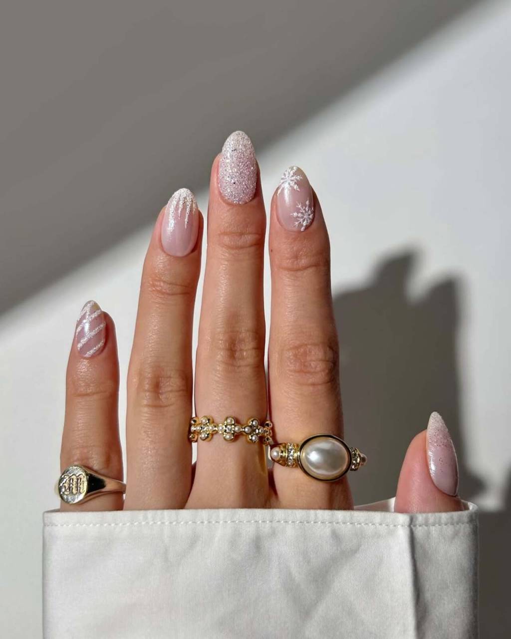 unhas-tematicas-inverno (2) Imagem de mão branca exibindo nail art branca temática para o inverno.