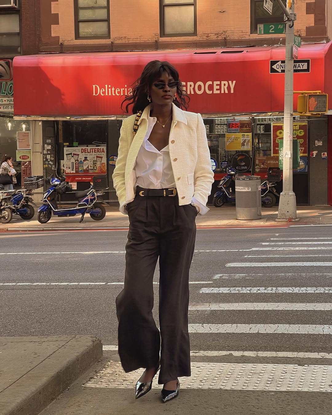 Imagem de visual com sobreposi&ccedil;&atilde;o de camisa branca com jaqueta amarela e cal&ccedil;a marrom.