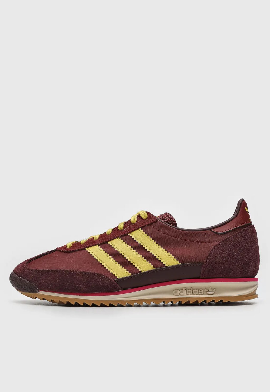 Foto de um tênis marrom e detalhes amarelos