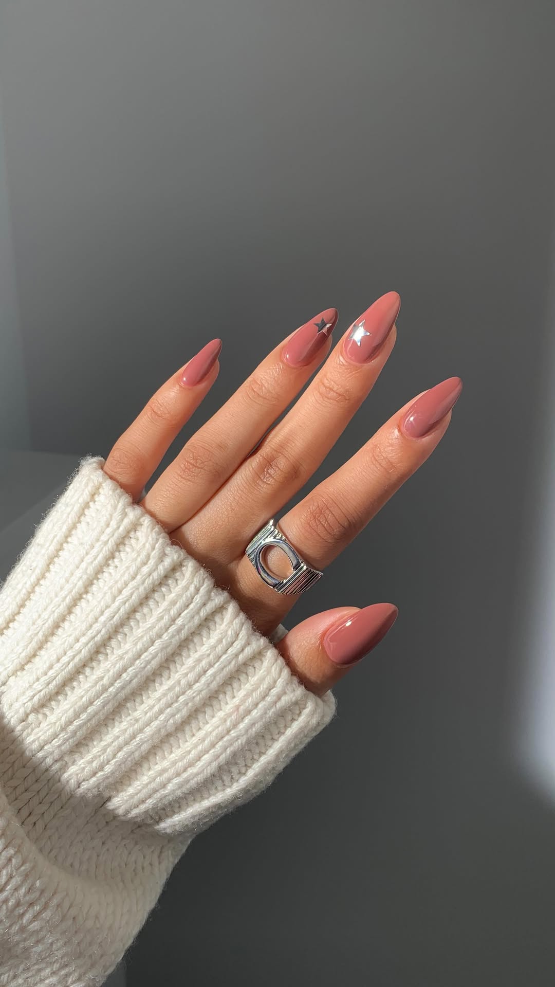 Unhas nude com estrelas prateadas decorativas