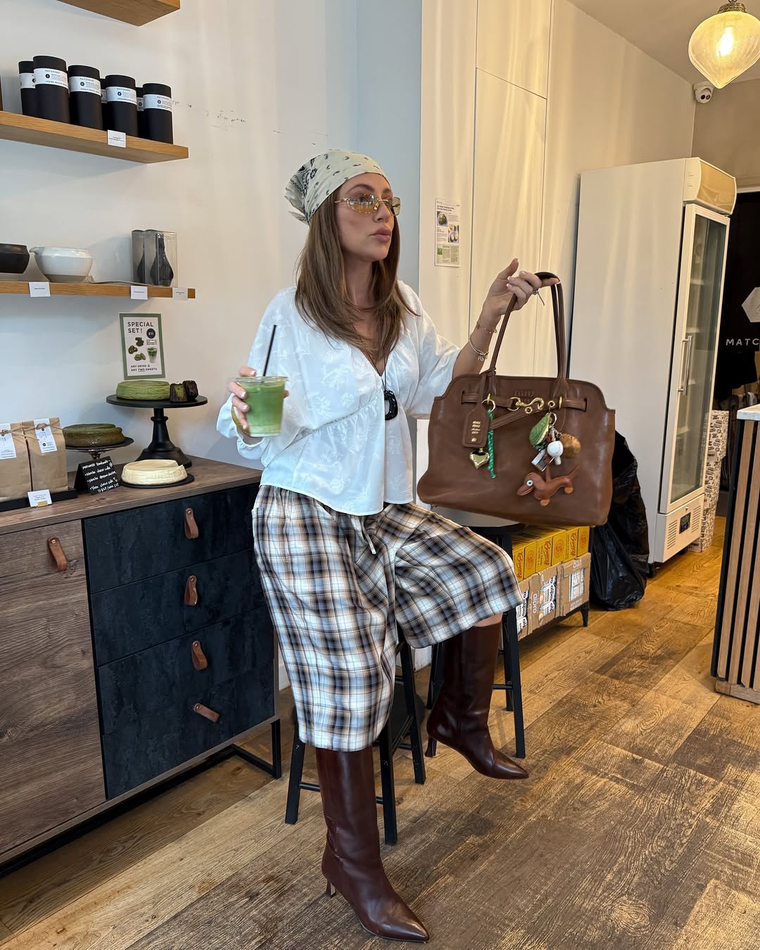 Bota de cano alto marrom com bermuda ampla e acess&oacute;rios cria look estiloso que alonga a silhueta