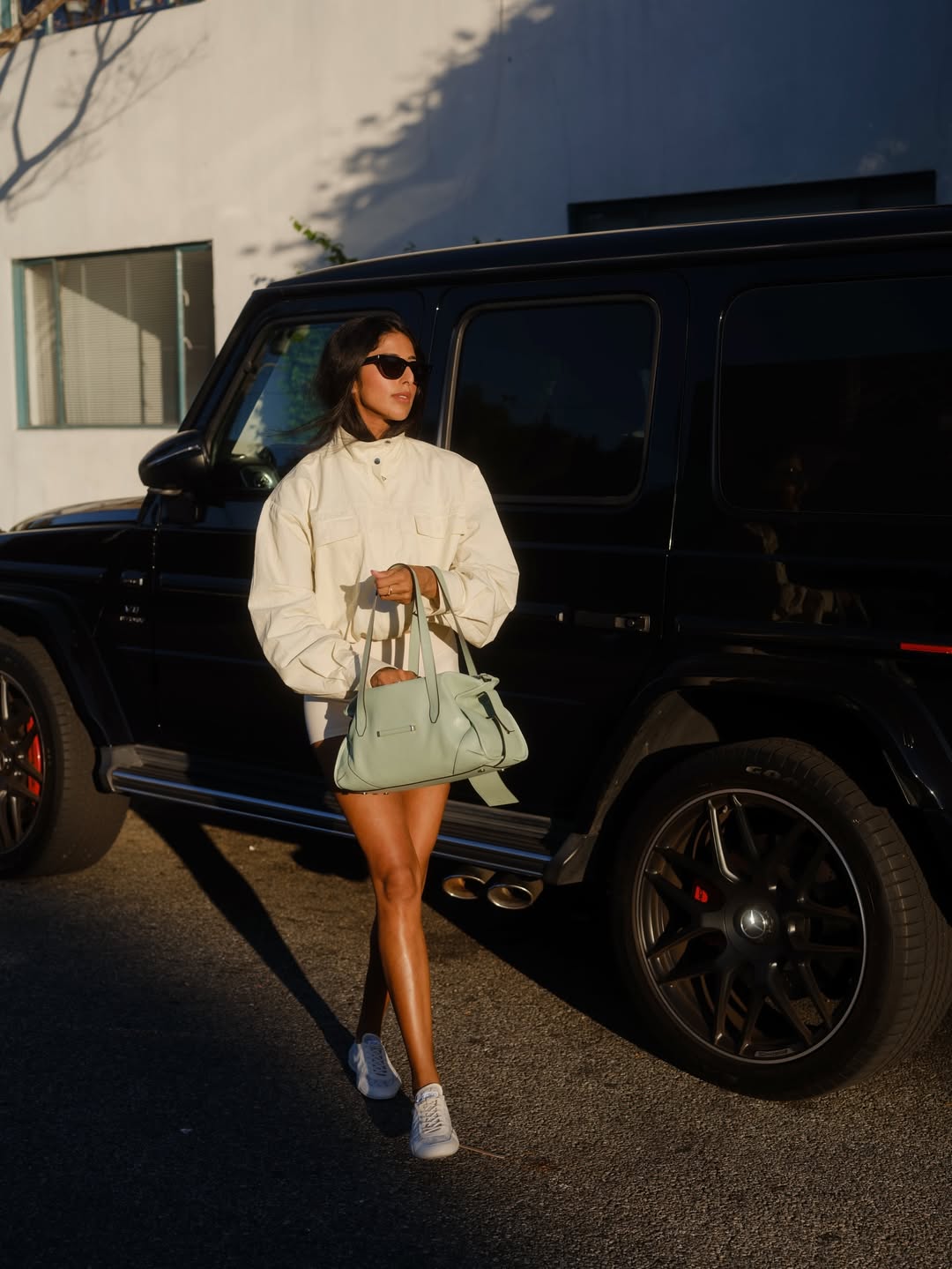 Mulher usando blusa de frio off white e bolsa verde menta