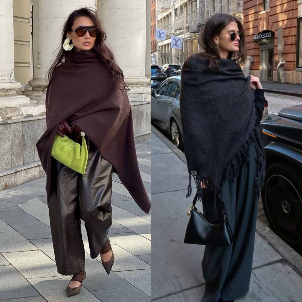 Duas mulheres em looks de inverno. &Agrave; esquerda, mulher de &oacute;culos escuros, poncho marrom, cal&ccedil;a de couro escura, sapatos de bico fino e bolsa verde-lim&atilde;o. &Agrave; direita, mulher de &oacute;culos escuros, xale preto com franjas, cal&ccedil;a larga escura e bolsa preta, em rua urbana