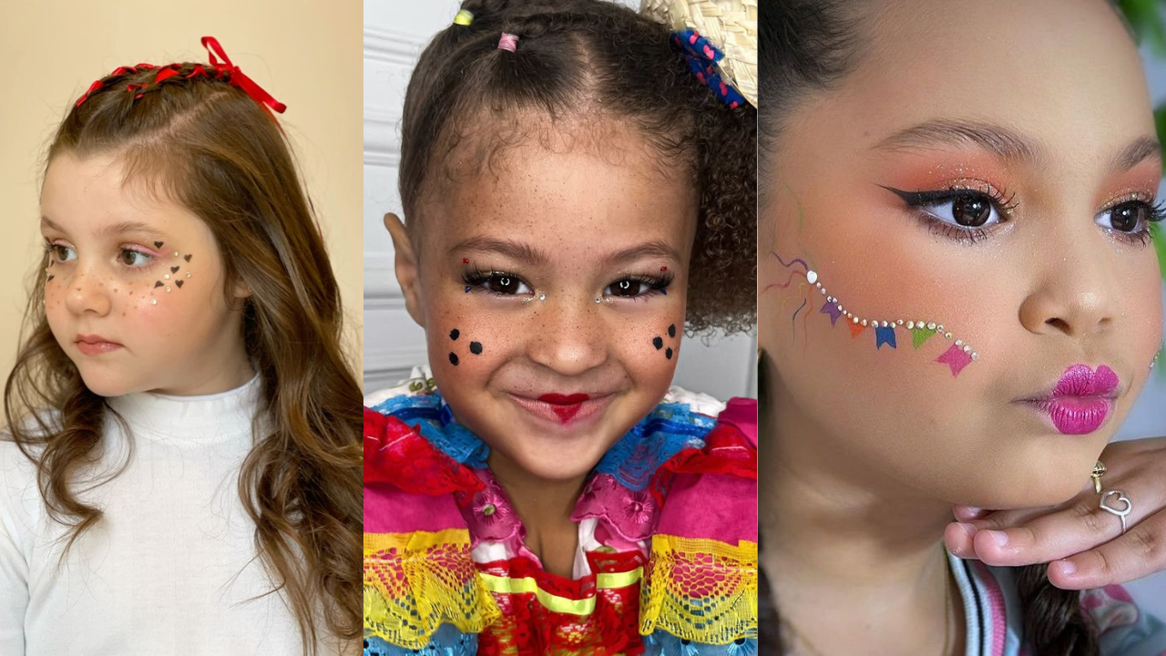 Três meninas com maquiagens festivas de São João. A primeira tem sardas falsas e corações no rosto. A segunda, sorrindo, usa batom de coração e pintinhas pretas. A terceira exibe bandeirinhas e strass na bochecha, com batom rosa vibrante