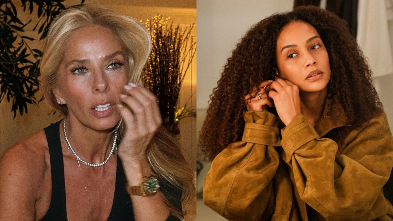 Duas mulheres em close-up: à esquerda, loira com colar de brilhantes e relógio dourado, mão no rosto; à direita, morena de cabelos cacheados, jaqueta marrom, colocando um brinco