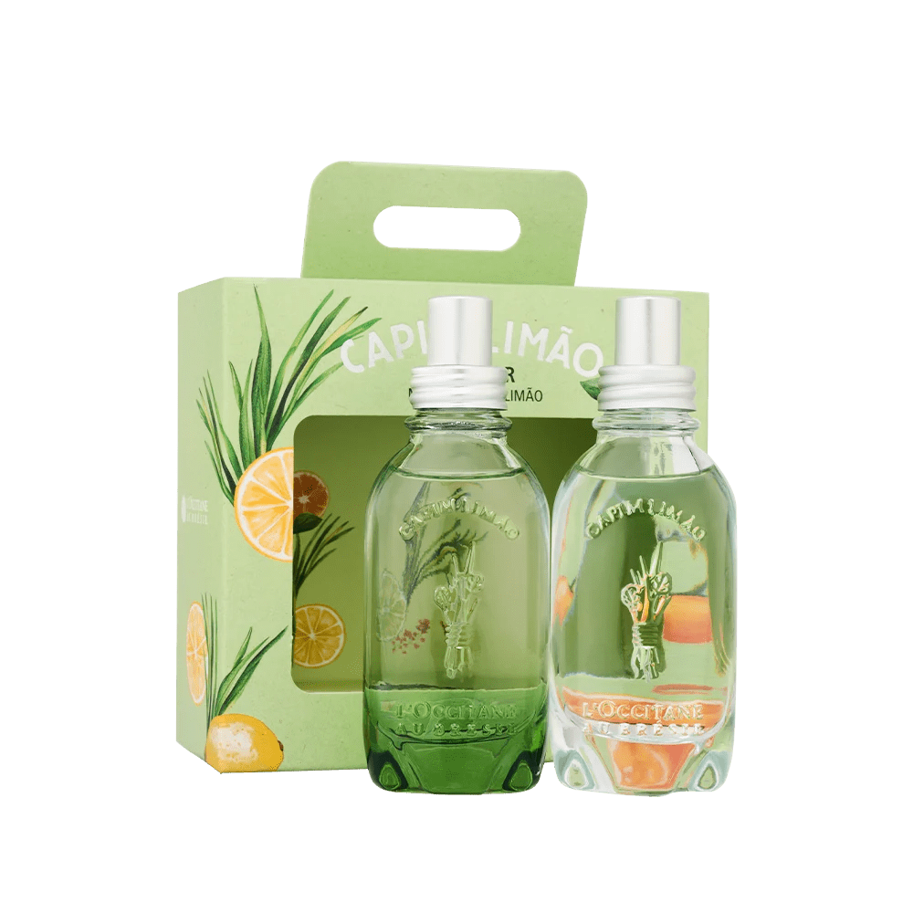 Duas garrafas de vidro transparente com l&iacute;quido verde claro, tampas prateadas e r&oacute;tulos Capim Lim&atilde;o, dentro de uma caixa verde com ilustra&ccedil;&otilde;es de capim-lim&atilde;o e fatias de lim&atilde;o