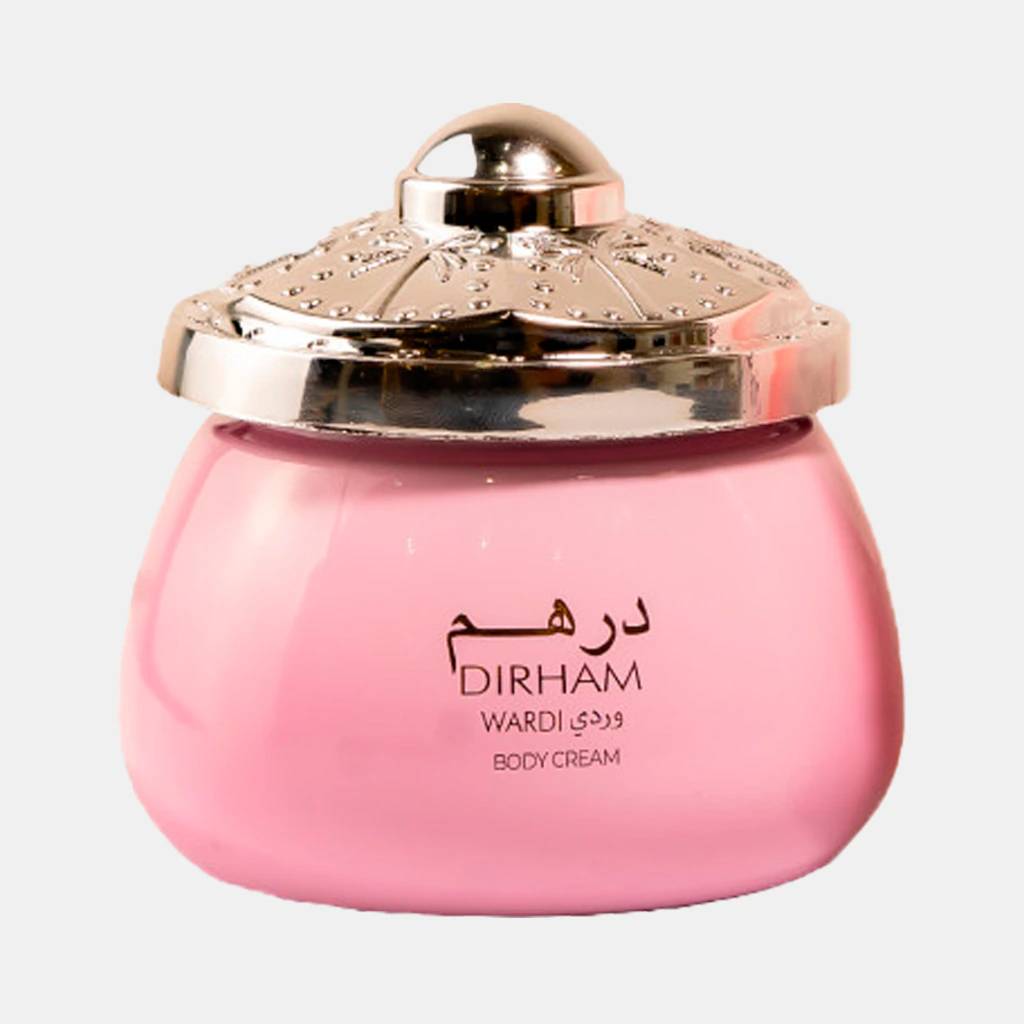 Pote de creme corporal Dirham Wardi rosa com tampa dourada ornamentada, detalhes em relevo e um puxador arredondado no topo