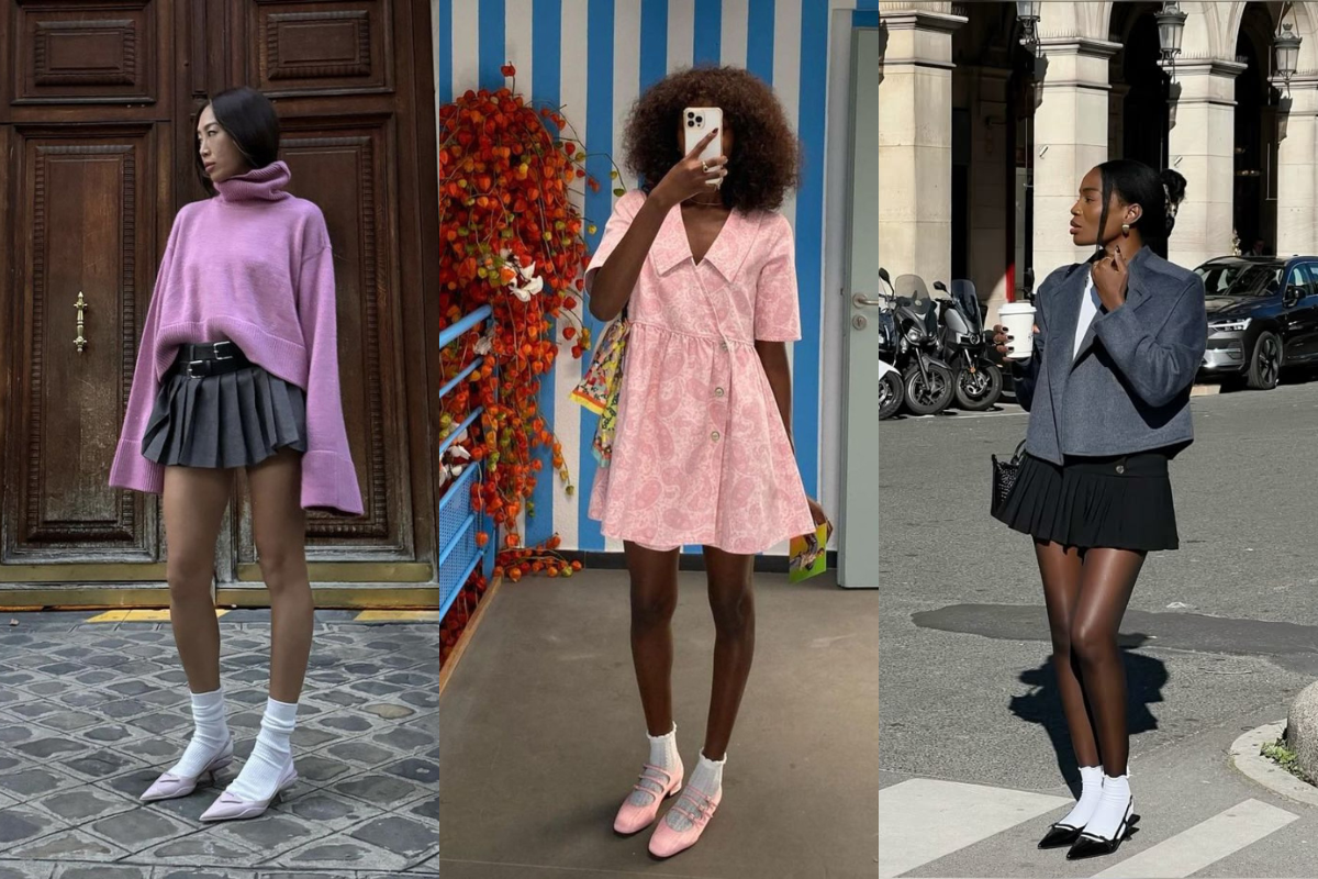 Três mulheres exibem looks de moda. A primeira, asiática, usa suéter lilás, minissaia cinza plissada, meias brancas e sapatos brancos de bico fino. A segunda, negra de cabelo cacheado, veste um vestido rosa estampado, meias brancas e sapatos rosa. A terceira, negra, usa blazer cinza, camiseta branca, minissaia preta plissada, meias brancas e sapatos pretos de bico fino