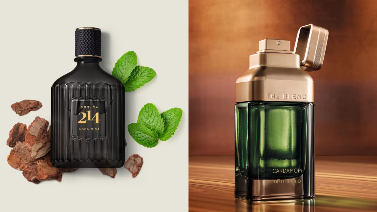 Dois frascos de perfume O Boticário. À esquerda, um frasco preto com tampa texturizada, Boticário 214 Dark Mint em dourado, cercado por folhas de hortelã e cascas de árvore. À direita, um frasco verde escuro com tampa dourada aberta, The Blend Cardamom O Boticário em dourado, sobre uma superfície de madeira
