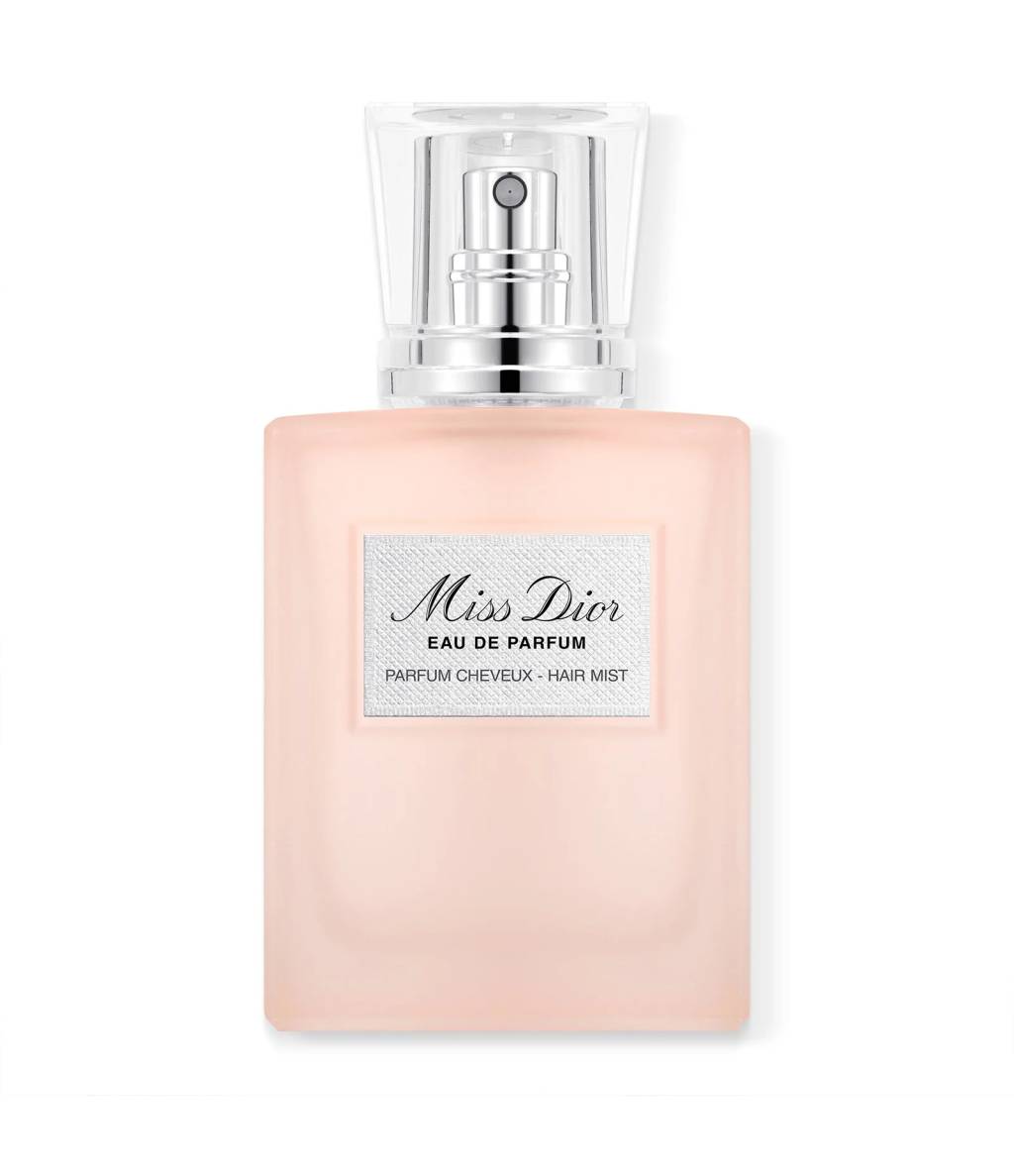 Frasco retangular de Miss Dior Eau de Parfum, cor rosa claro fosco, com tampa transparente e borrifador prateado. O r&oacute;tulo branco no centro exibe Miss Dior Eau de Parfum Parfum Cheveux - Hair Mist em preto