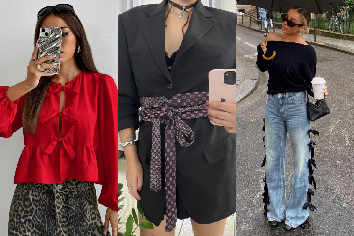 Três mulheres exibindo looks de moda. À esquerda, uma mulher com blusa vermelha de laços e saia animal print. No centro, uma mulher com blazer preto e cinto de gravata estampada. À direita, uma mulher com blusa preta ombro a ombro, jeans com laços laterais, segurando guarda-chuva e copo de café na rua