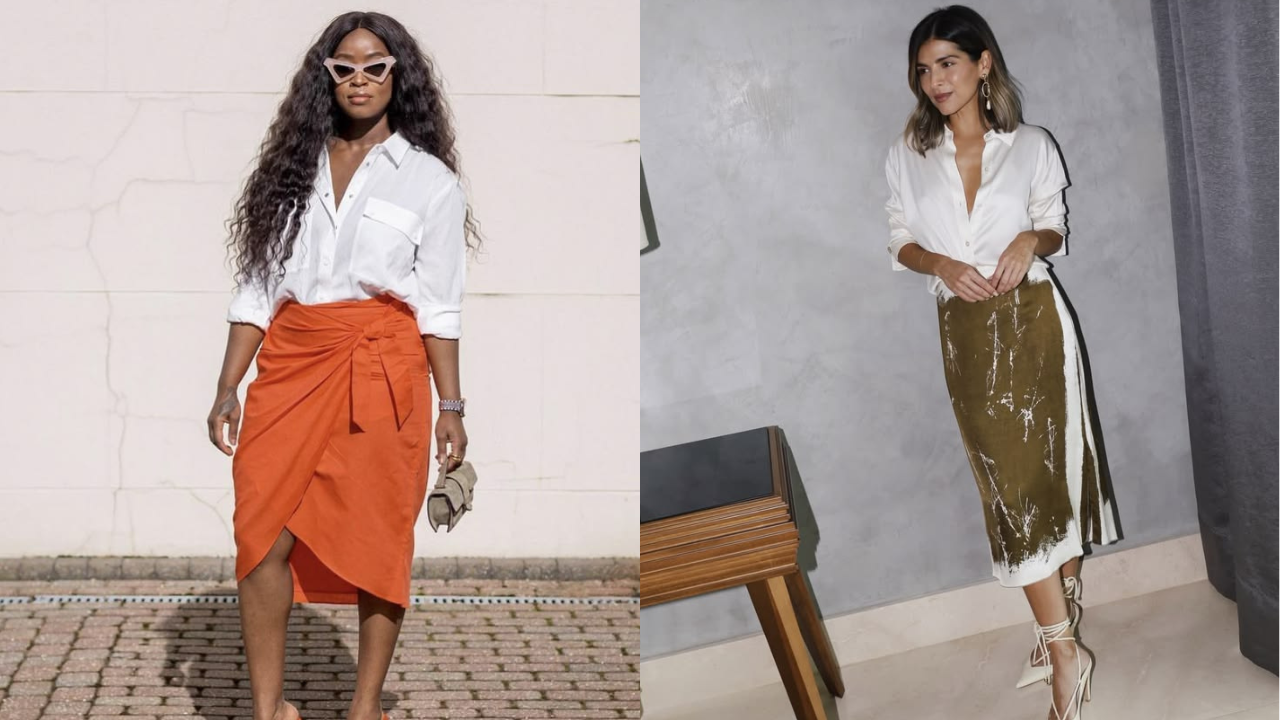 Duas mulheres posam com camisas brancas e saias midi. À esquerda, uma mulher negra de óculos gatinho e saia laranja com amarração. À direita, uma mulher branca com saia verde-oliva estampada e sandálias de amarração